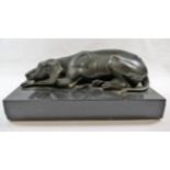 A bronze of an English foxhound lying down, on a rectangular black marble base, the bronze 23.