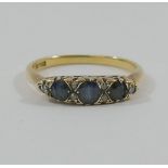An 18 carat gold sapphire and diamond carved half hoop ring,