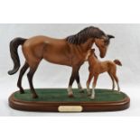 A Royal Doulton horse group, 'First Foal', on oval wooden base, total height 17.