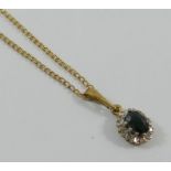 A 9 carat gold sapphire and diamond oval cluster pendant,