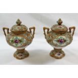 A pair of small Noritake two-handled lidded vases, hand painted with floral panels, 11.