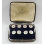 A set of four gold, mother of pearl and blue enamel buttons and a pair of matching cuff links,