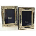 A pair of modern rectangular silver photograph frames,