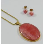 A 9 carat gold rhodochrosite oval pendant and chain, the oval pendant 4cm x 3cm, London 1977,