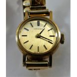A ladies Longines 9 carat gold wrist watch, the round face with baton numerals, London 1973,