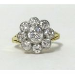 A fine 18ct diamond cluster ring set with nine diamonds, finger size J.