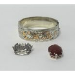 A silver and cornelian style pendant, a silver bangle heightened in gold and a crown brooch (3).