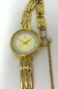 A ladies 9ct yellow gold quartz wristwatch and 9ct yellow gold strap, the watch carries a 9ct gold