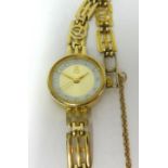 A ladies 9ct yellow gold quartz wristwatch and 9ct yellow gold strap, the watch carries a 9ct gold