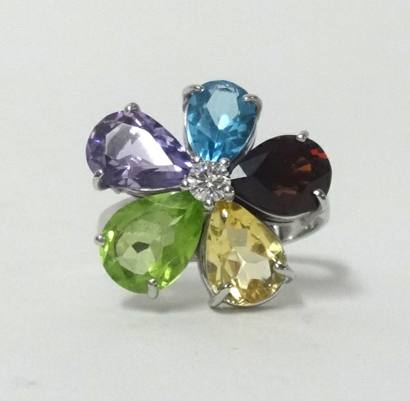 An 18ct white gold multi stone flower ring, set with amethyst, garnet, diamond, topaz etc, finger