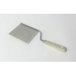 An unusual comb, the silver handle stamped Cartier 'Sterling Handle', length 27cm, maximum width