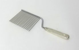 An unusual comb, the silver handle stamped Cartier 'Sterling Handle', length 27cm, maximum width