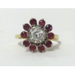A ruby and diamond cluster ring, set in yellow gold, indistinct mark, finger size K.