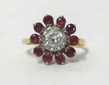 A ruby and diamond cluster ring, set in yellow gold, indistinct mark, finger size K.