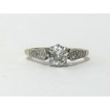 An 18ct diamond single stone ring, approx 0.70cts, with further diamonds to the shoulders, finger