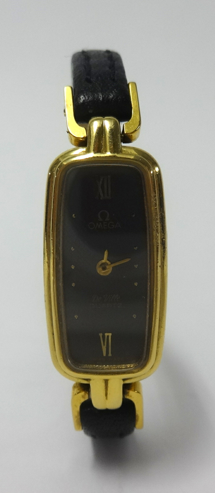 Omega, a ladies De Ville quartz wristwatch in yellow metal together with a Gucci ladies fashion