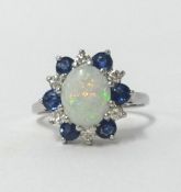 An 18ct white gold cluster ring set with central opal and within a cluster of sapphire and diamonds,