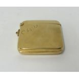 An early 20th century 9ct gold vesta case a hinged flap on the front, revealing a hidden miniature