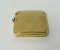 An early 20th century 9ct gold vesta case a hinged flap on the front, revealing a hidden miniature