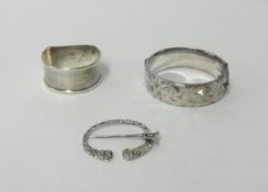 A silver napkin ring, bangle and celtic pin (3).