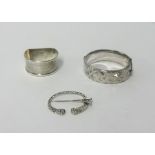 A silver napkin ring, bangle and celtic pin (3).