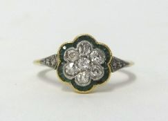 An Edwardian 18ct emerald and diamond cluster ring, finger size L.