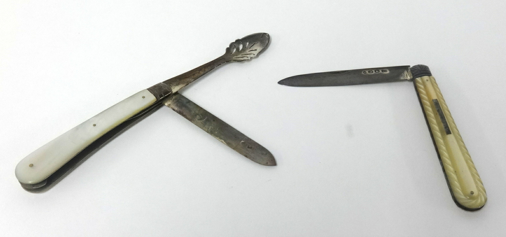 An early 20th century silver and mother-of-pearl handled folding twin fruit knife and Patent