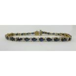 A 9ct gold line bracelet set with sapphire and diamonds, overall length approx 19cm.