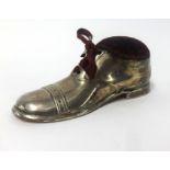An Edwardian silver pin cushion, modelled as a boot, indistinct makers mark, 'S.B & S? (possibly