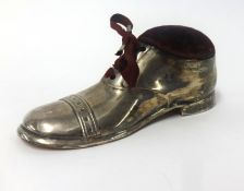 An Edwardian silver pin cushion, modelled as a boot, indistinct makers mark, 'S.B & S? (possibly