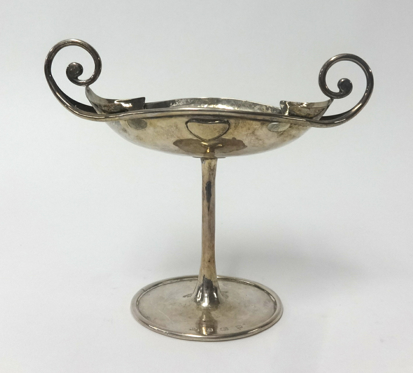 George Connell, an Edwardian Arts and Crafts silver stem dish with scroll handle decoration and