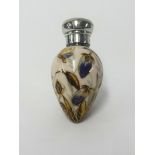 A Victorian silver and porcelain scent bottle of egg shape decorated with flowers and a butterfly in