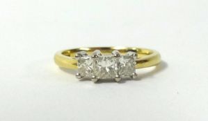 An 18ct diamond three stone ring set with three princess cut diamonds, finger size T.