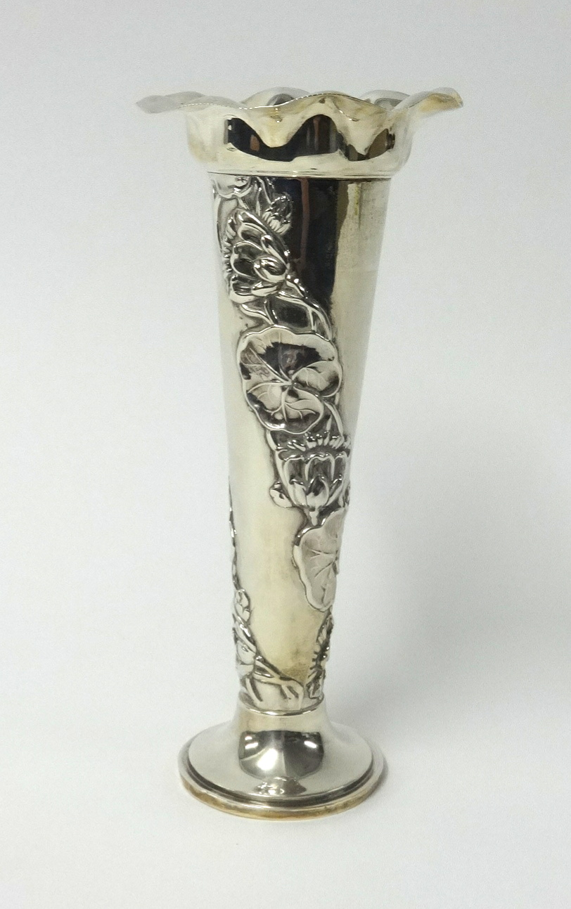 A silver trumpet vase, maker, 'S.M & Co' with embossed decoration of flowers, height 20cm, approx