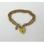 A 9ct gold double chain and curb link bracelet with padlock, approx 25.40gms.