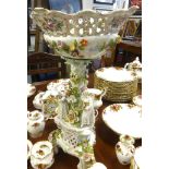 A large 20th century German porcelain centre piece, encrusted with flowers, with gilt decoration and