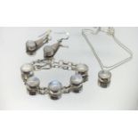 A silver and moonstone style modern bracelet, necklace and pair of earrings.