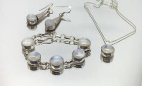 A silver and moonstone style modern bracelet, necklace and pair of earrings.