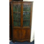 A reproduction mahogany serpentine corner cabinet, set of six Georgian style ladder back and oak