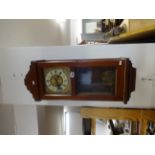 A mahogany case drop dial wall clock with eight day movement striking on a gong.