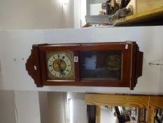 A mahogany case drop dial wall clock with eight day movement striking on a gong.