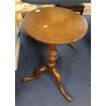 A Victorian mahogany tripod wine table.