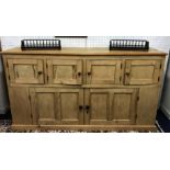 A stripped pine kitchen dresser comprising an arrangement of three cupboards, length approx 193cm.