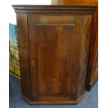 A Georgian oak and mahogany hanging corner cupboard.