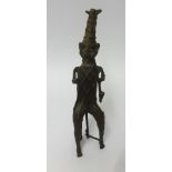 A 20th Century Benin bronze sculpture of a man with pipe, height 32cm.
