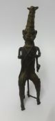 A 20th Century Benin bronze sculpture of a man with pipe, height 32cm.