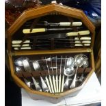 A canteen of cutlery by Dixon in an oak and inlaid Arts and Crafts style fitted box.