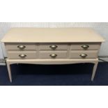 An overpainted stag style six drawer dressing table, width 130cm.