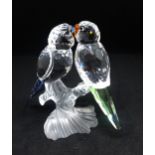 1Swarovski, a pair of Budgies on a frosted perch with blue and green tails, boxed.
