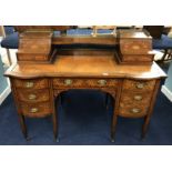 An Edwardian 'Carlton House' style desk in mahogany with marquetry inlay throughout, the upper